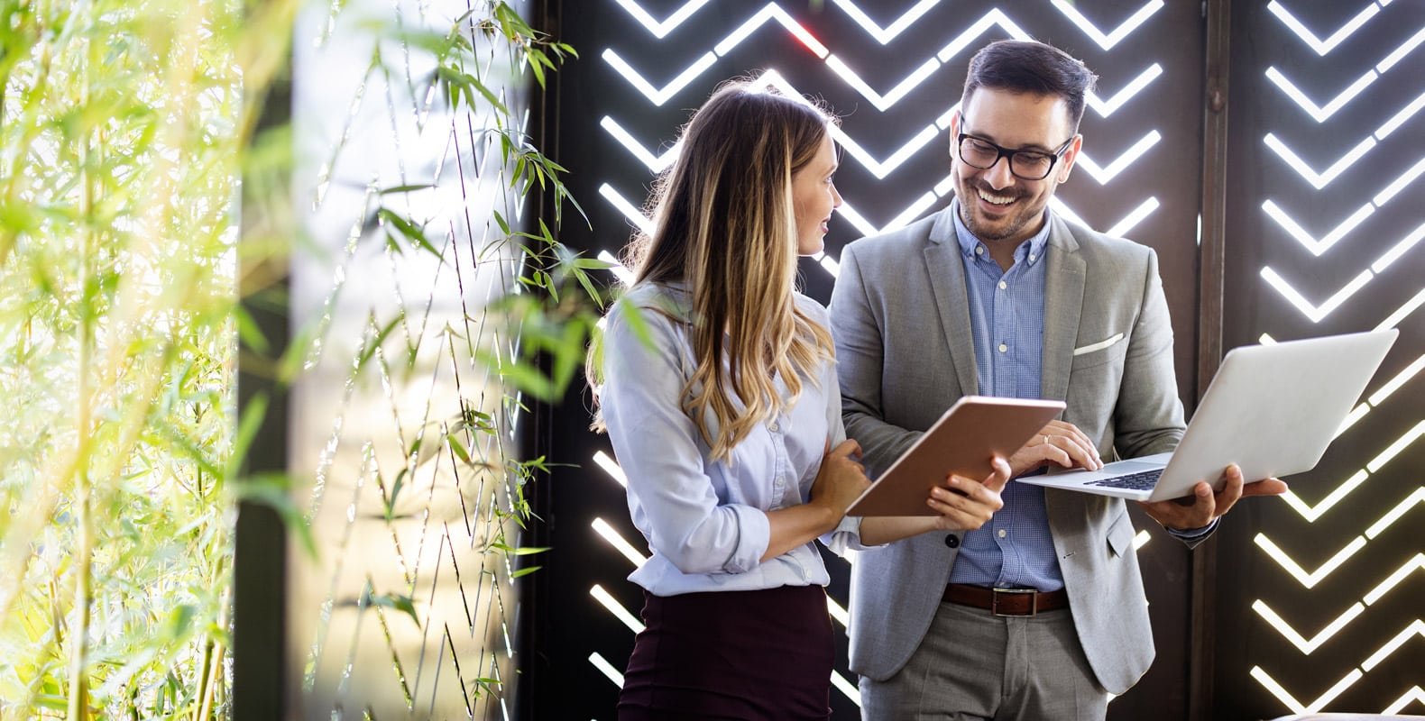A man & woman with business related majors at work in their new careers.