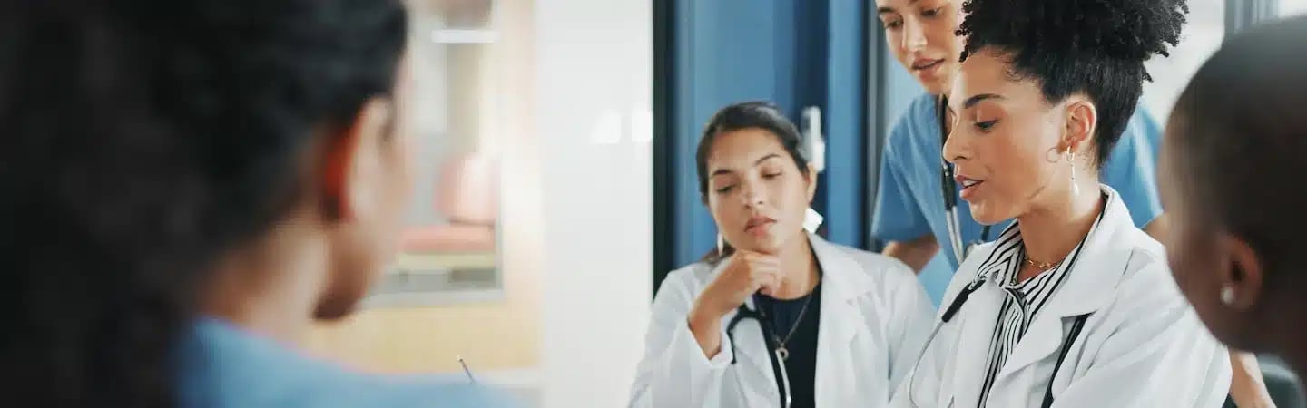 Healthcare professionals having a discussion in a hospital setting.