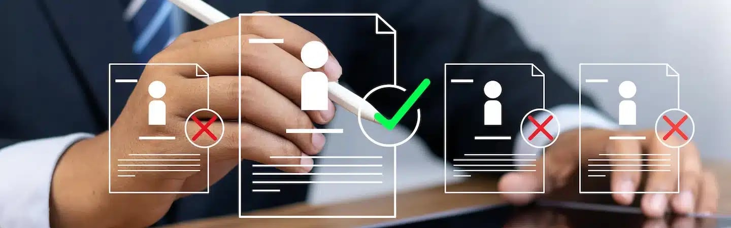 A person uses a stylus to select a digital profile with a green check among others with red X marks on a tablet.
