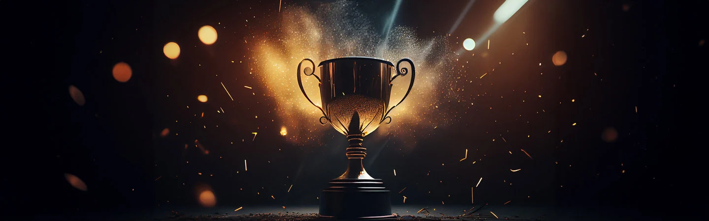 A trophy illuminated by dramatic lighting and surrounded by flying particles against a dark background.